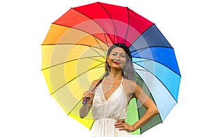 Attractive and happy Asian woman holding rainbow colorful umbrella or parasol  smiling playful isolated on white background in