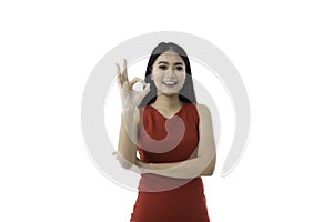 Attractive happy beautiful young Asian female businessperson in casual business red dress is smiling, showing ok sign gesture,