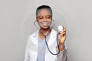 Attractive happy doctor woman medical worker in lab coat on white background