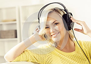 Attractive happy girl listening music at home.