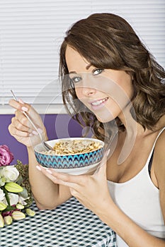 Attractive Happy Healthy Young Woman Eating Breakfast Cereal