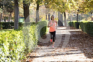 Attractive and happy runner woman in Autumn sportswear running a