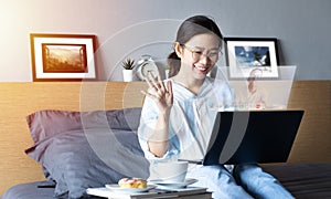 Attractive happy woman using video call, make online conversation via laptop computer on bed from her room, having video chat