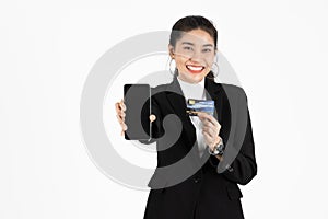 Attractive happy young Asian business woman showing screen of mobile smart phone over white isolated background. Social network,