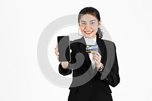 Attractive happy young Asian business woman showing screen of mobile smart phone over white isolated background. Social network,