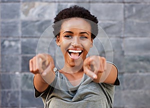 Attractive happy young black woman pointing fingers