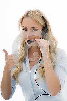 Attractive Happy Young Business Woman Using a Telephone Headset