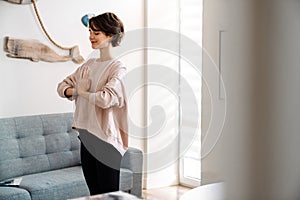 Attractive healthy calm young woman meditating