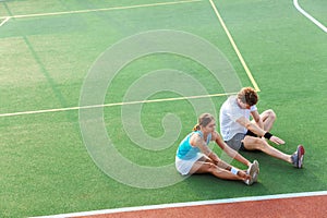 Attractive healthy fitness couple doing stretching