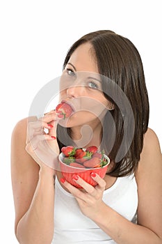 Attractive Healthy Young Woman Eating a Bowl of Fresh Ripe Juicy Strawberries