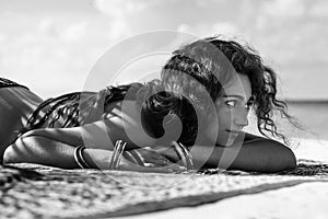 Attractive hippie woman taking sunbath on the beach on tropical