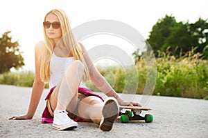 Attractive hipster teenage girl with skateboard