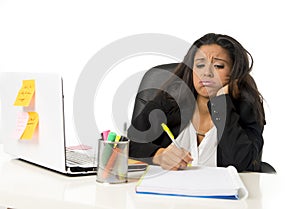 Attractive hispanic businesswoman or secretary suffering breakdown and headache in stress at office