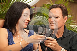 Attractive Hispanic and Caucasian Couple Drinking