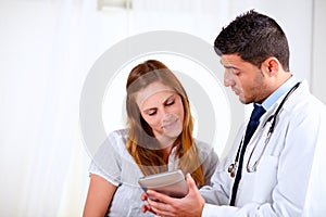 Attractive hispanic doctor conversing with a woman photo