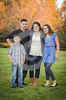 Attractive Hispanic Family Portrait in a Colorful Fall Outdoor S