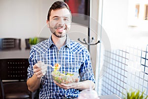 Attractive Hispanic man eating healthy food