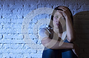 attractive Hispanic woman sitting at home floor frustrated suffe