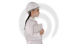 Attractive Hispanic woman in white lab coat and white safety har