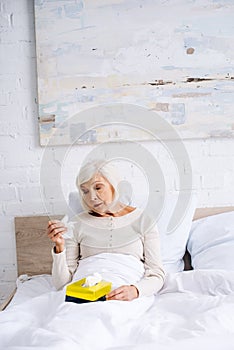 attractive and ill senior woman holding
