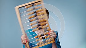 Attractive joyful stewardess is holding an abacus. Low-cost airline.