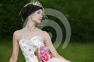 Attractive lady in formal gown in the park