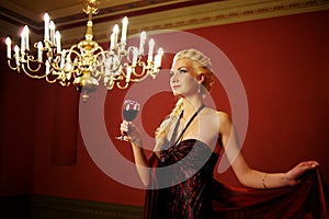 Attractive lady with a glass of red wine.