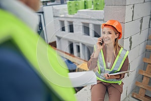 Attractive lady in a helmet calling on the cellphone