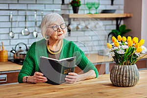 Attractive lady in years holding an open Holy Bible