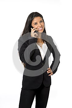 Attractive latin businesswoman in formal office suit smiling happy talking on mobile phone