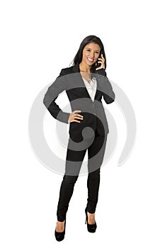 Attractive latin businesswoman in formal office suit smiling happy talking on mobile phone