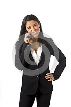 Attractive latin businesswoman in formal office suit smiling happy talking on mobile phone