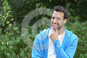 Attractive latin guy looking at camera in a park