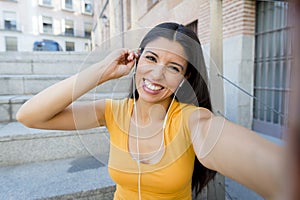 Attractive latin woman listening to music on her smart phone