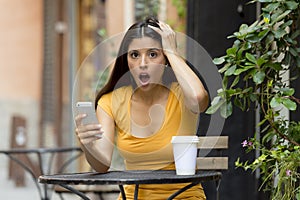 Attractive latin woman shocked on her smart phone
