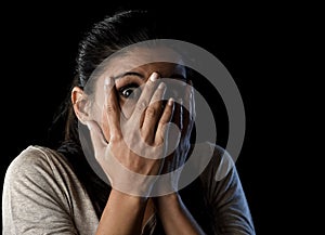 Attractive Latin woman scared terrorized and horrified covering her eyes