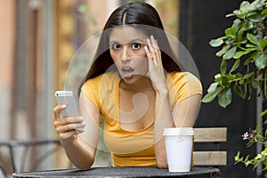 Attractive latin woman shocked on her smart phone