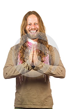 Attractive, laughing hippie with hands together.