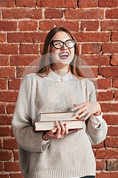 Attractive laughing woman with books portrait