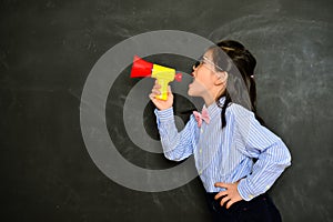 Attractive little girl teacher using loudspeaker
