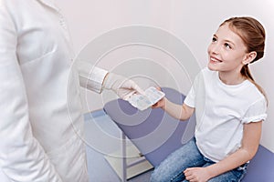 Attractive little patient sitting in consulting room