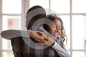 Attractive loving African American girlfriend embrace boyfriend