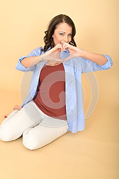 Attractive Lustful Romantic Happy Young Woman Making Heart Shape with Hands