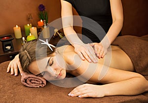 Attractive lying young woman in spa salon