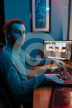 Male Video Editor Working on His Personal Computer with Big Display photo