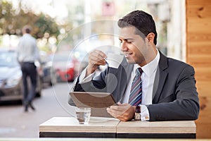 Attractive male worker is enjoying espresso in