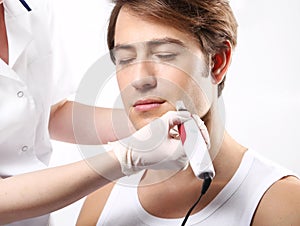 Attractive man in a beauty salon, micro needle mesotherapy treatment