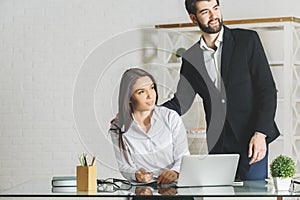 Attractive man and businesswoman working on project