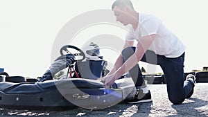 Attractive man checking tire pressure on his gocart