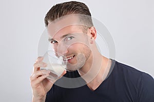 Attractive man drinking milk